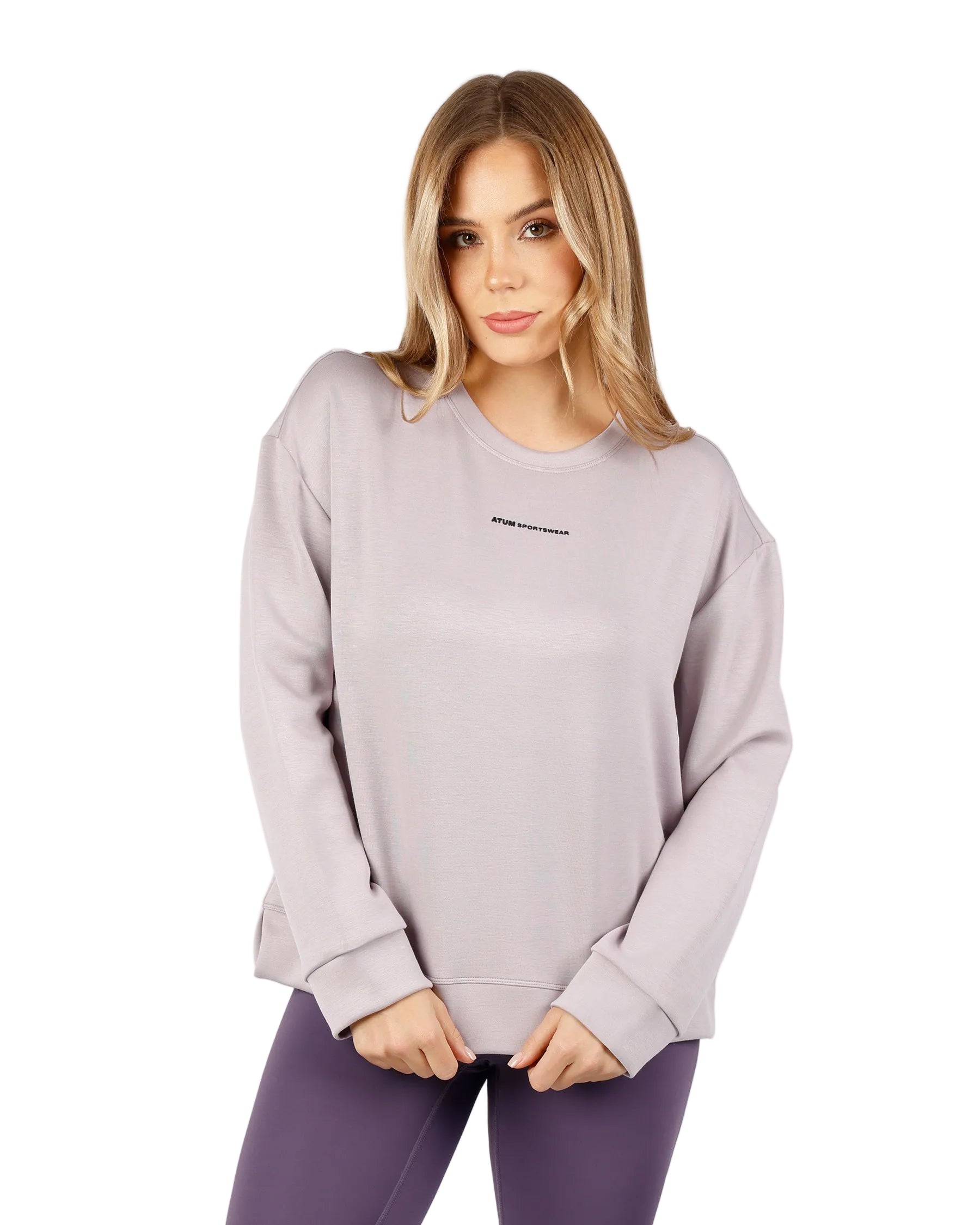 Woman wearing a light Purple sweatshirt with a brand logo on a white background